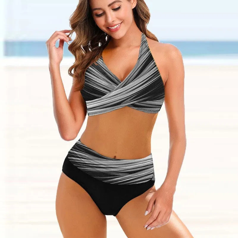 Women's striped tie-dye high-waisted bikini set with a backless design on a mannequin.