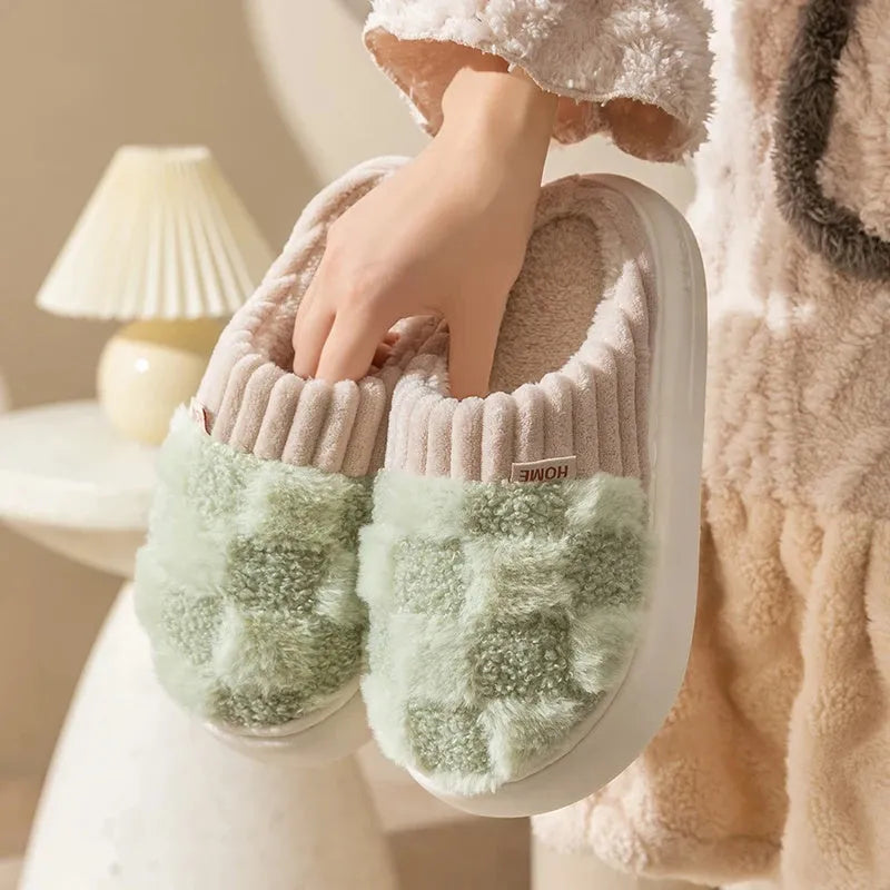 Plaid pattern women's slippers with plush lining and a light-coloured non-slip PVC sole, shown in a grey colour option.