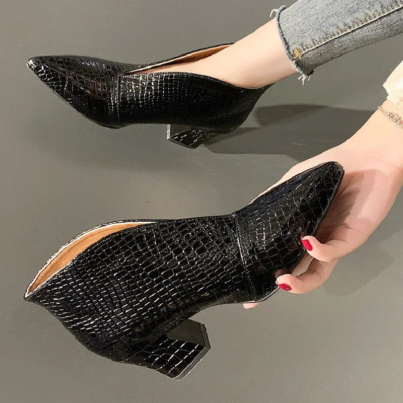 Women's black V-cut Martin boots with embossed PU upper and chunky heel on a neutral background.