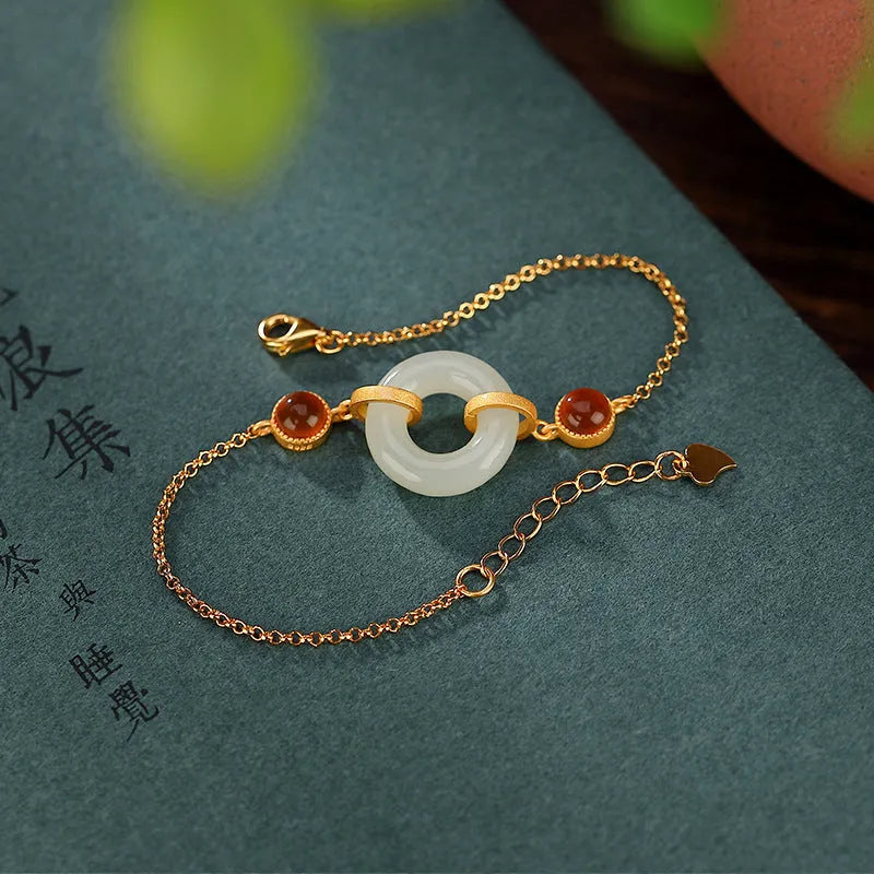 Gold-plated S925 sterling silver bracelet with inlaid natural Hetian jade stone and adjustable peace buckle clasp.