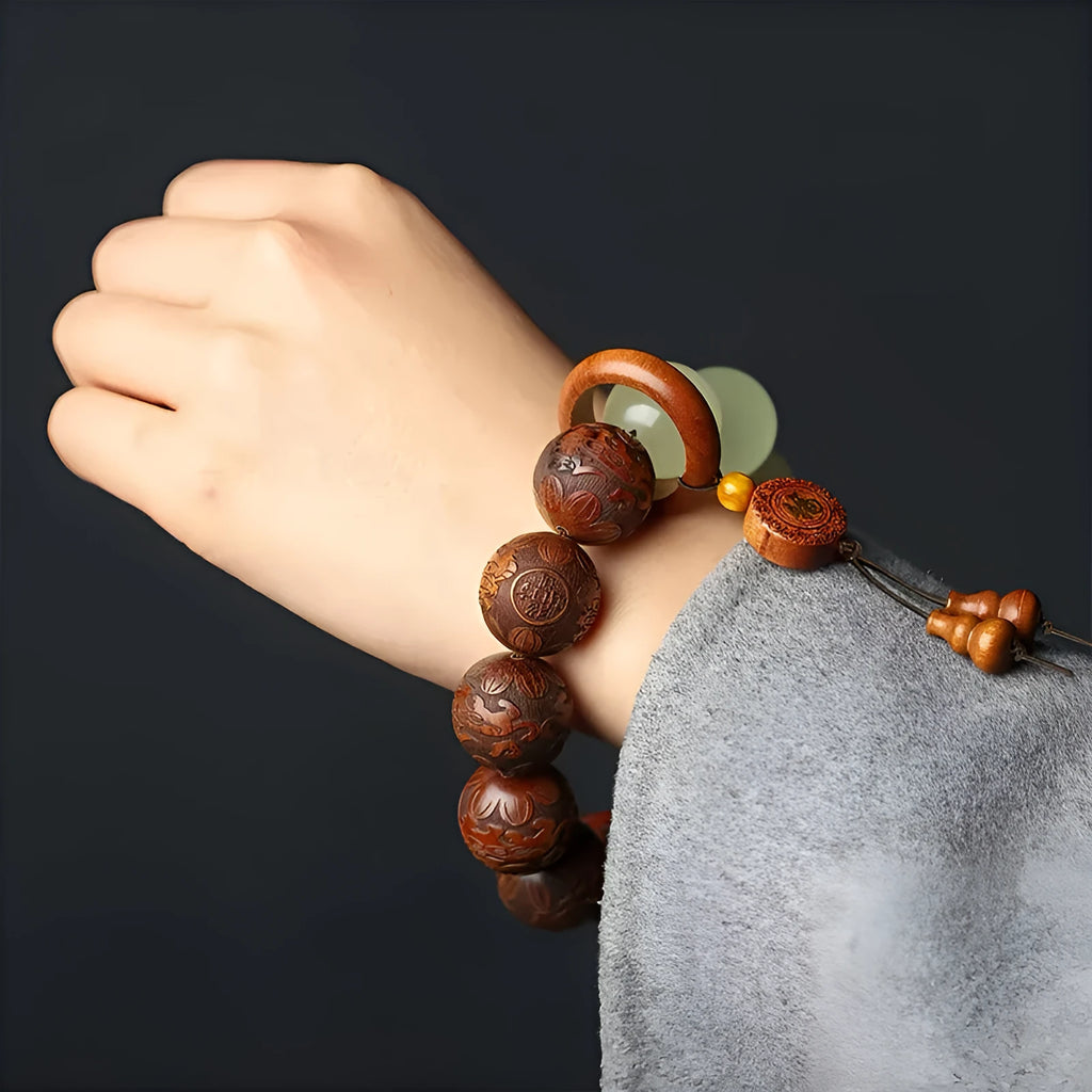 Rosewood bracelet with carved Fu character design and flexible ring construction in amass fortunes colour