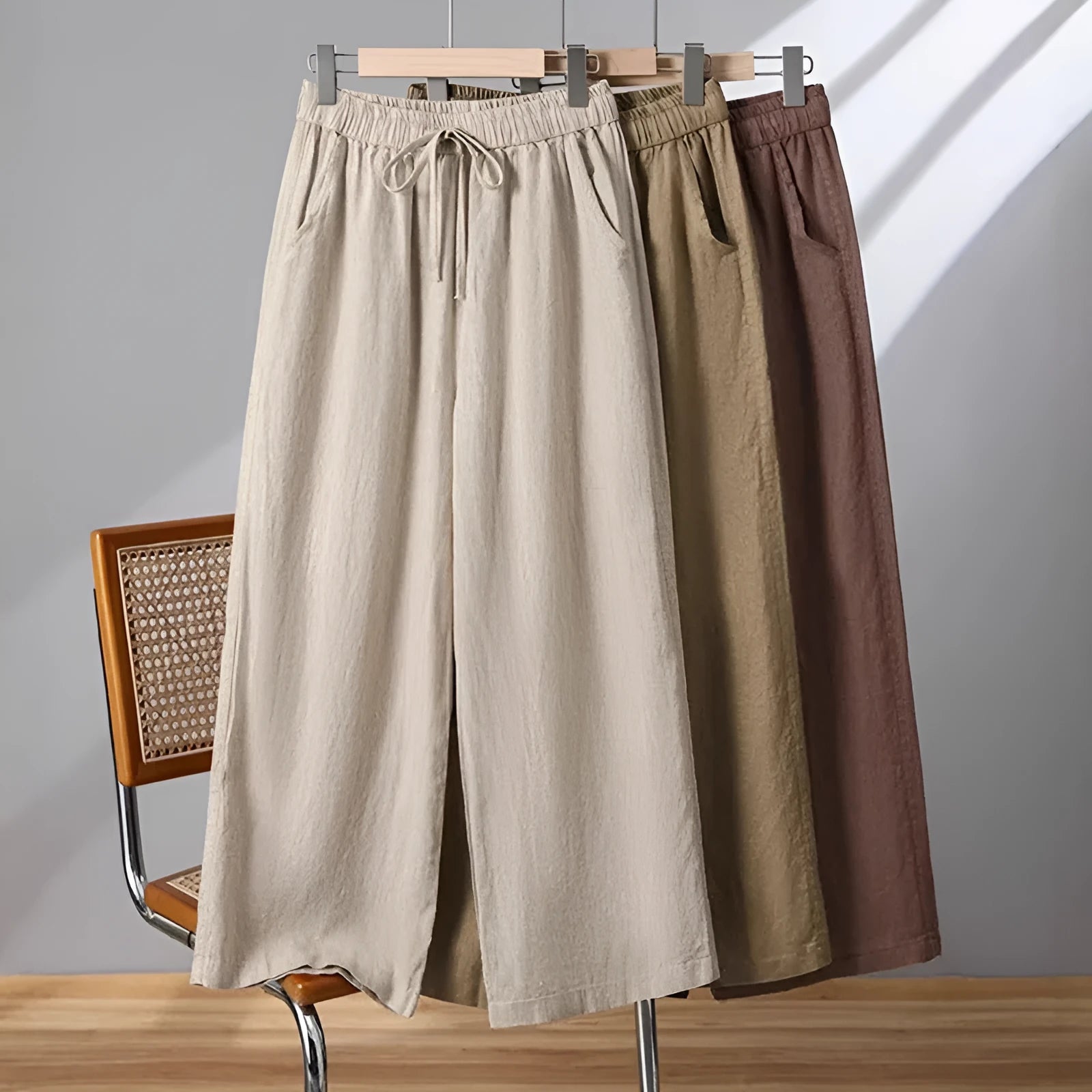 Women's apricot straight-leg casual trousers with elastic waist and drawstring detail laid flat