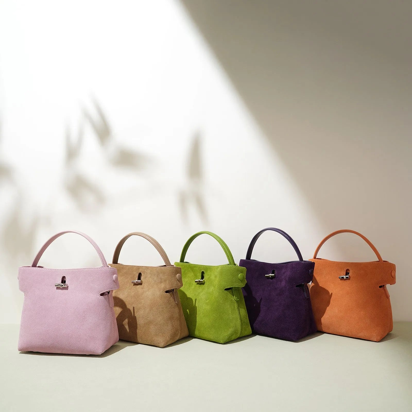 Women's mini Korean-style simple messenger bag in two-layer matte cowhide, bucket shape with lock opening, internal compartments
