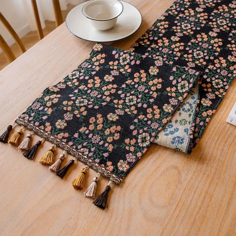 Nordic jacquard table runner with tassel fringe in dark blue with striped pattern on wooden table