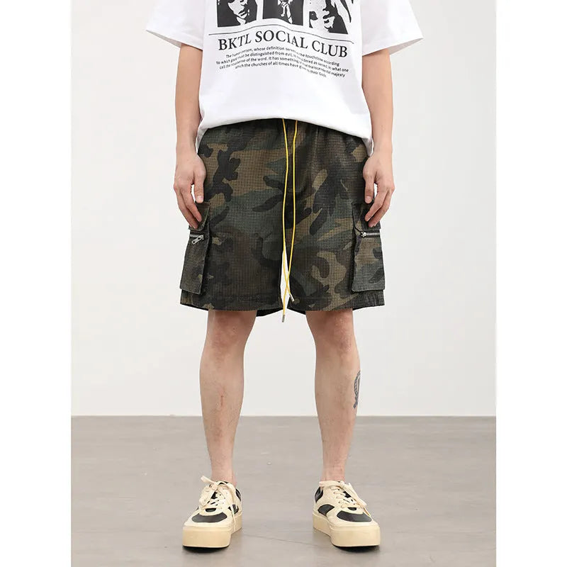 Men's camouflage cargo shorts with multiple pockets showing cropped length and mid-waist design