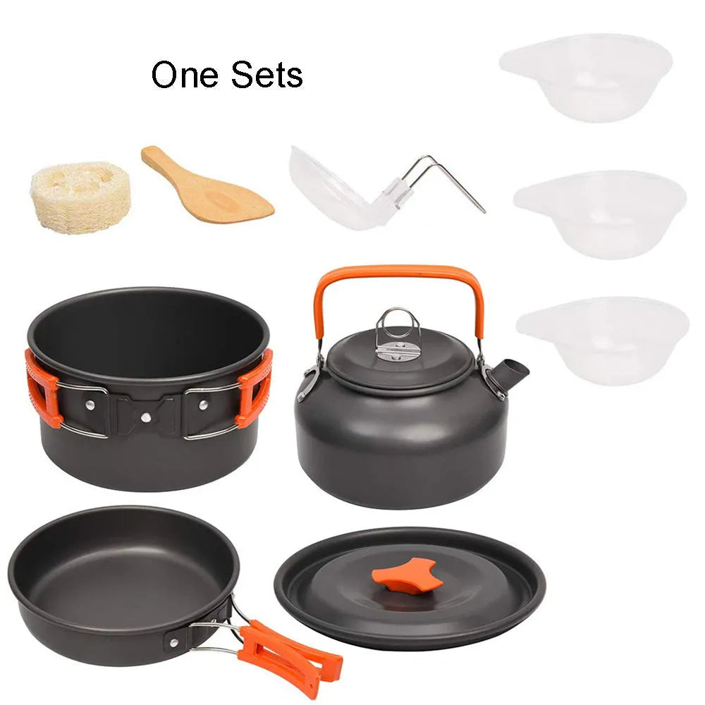 Orange camping cookware set with aluminium pots, pan, and utensils in a mesh bag