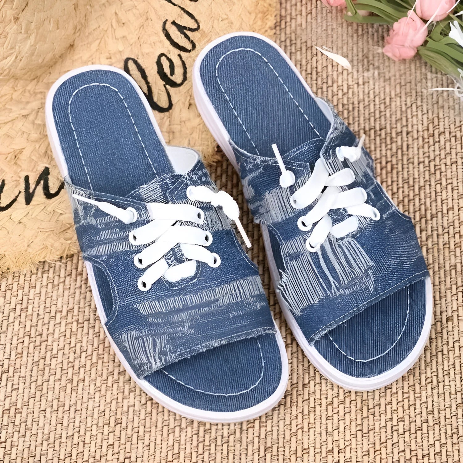 Blue women's flat canvas Roman slippers with a cloth upper and rubber sole.