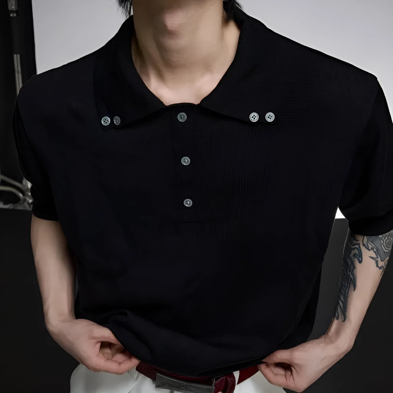 Men's black slim-fit double collar knit short sleeve shirt laid flat showing lapel detail