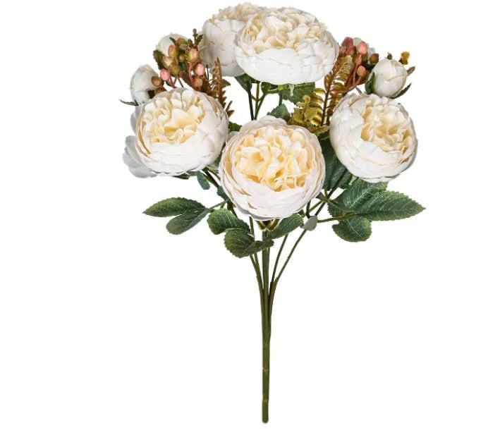 Silk artificial peony bouquet in champagne colour on a table for home or wedding decor.