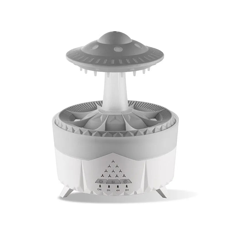 White cloud-shaped humidifier with raindrop mist and coloured night light on wooden table