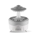 White cloud-shaped humidifier with raindrop mist and coloured night light on wooden table