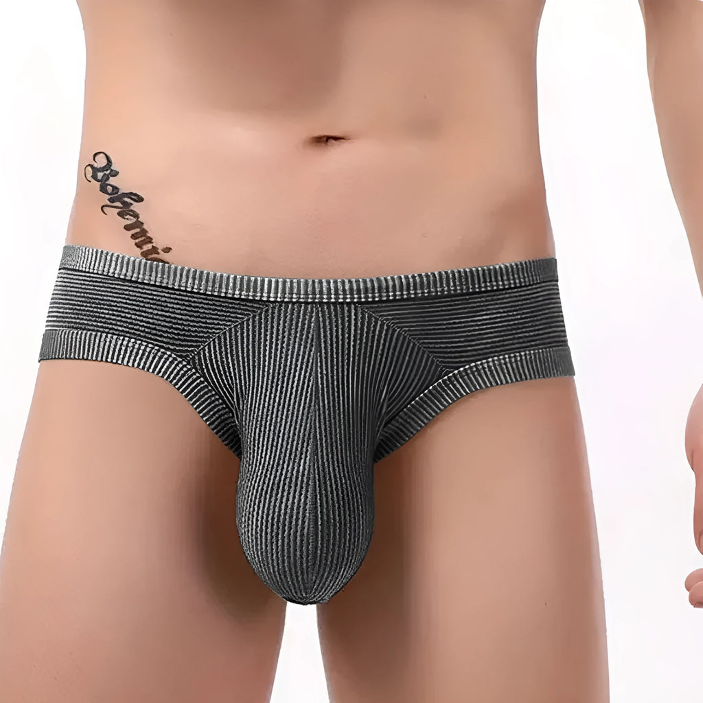 Men's black cotton briefs with a hollow back design and raised 3D pattern on the front.