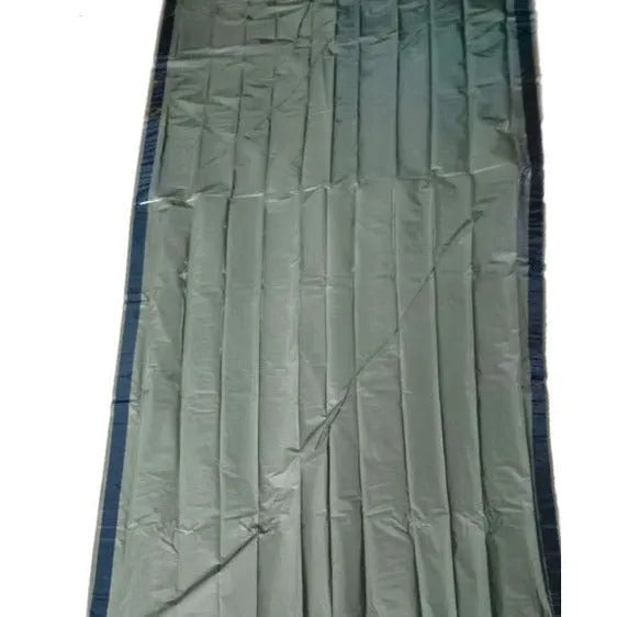 Orange aluminium foil emergency sleeping bag with drawstring bag and whistle on ground