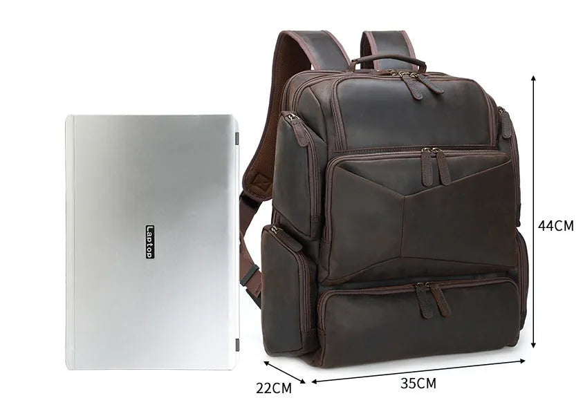 Dark brown retro crazy horse leather backpack for men open to show 17-inch laptop compartment and internal organisers.