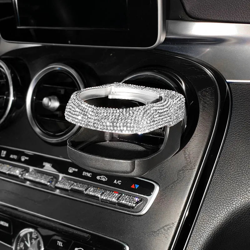 Diamond-decorated car cup holder bracket mounted on air vent in blue rhinestone finish