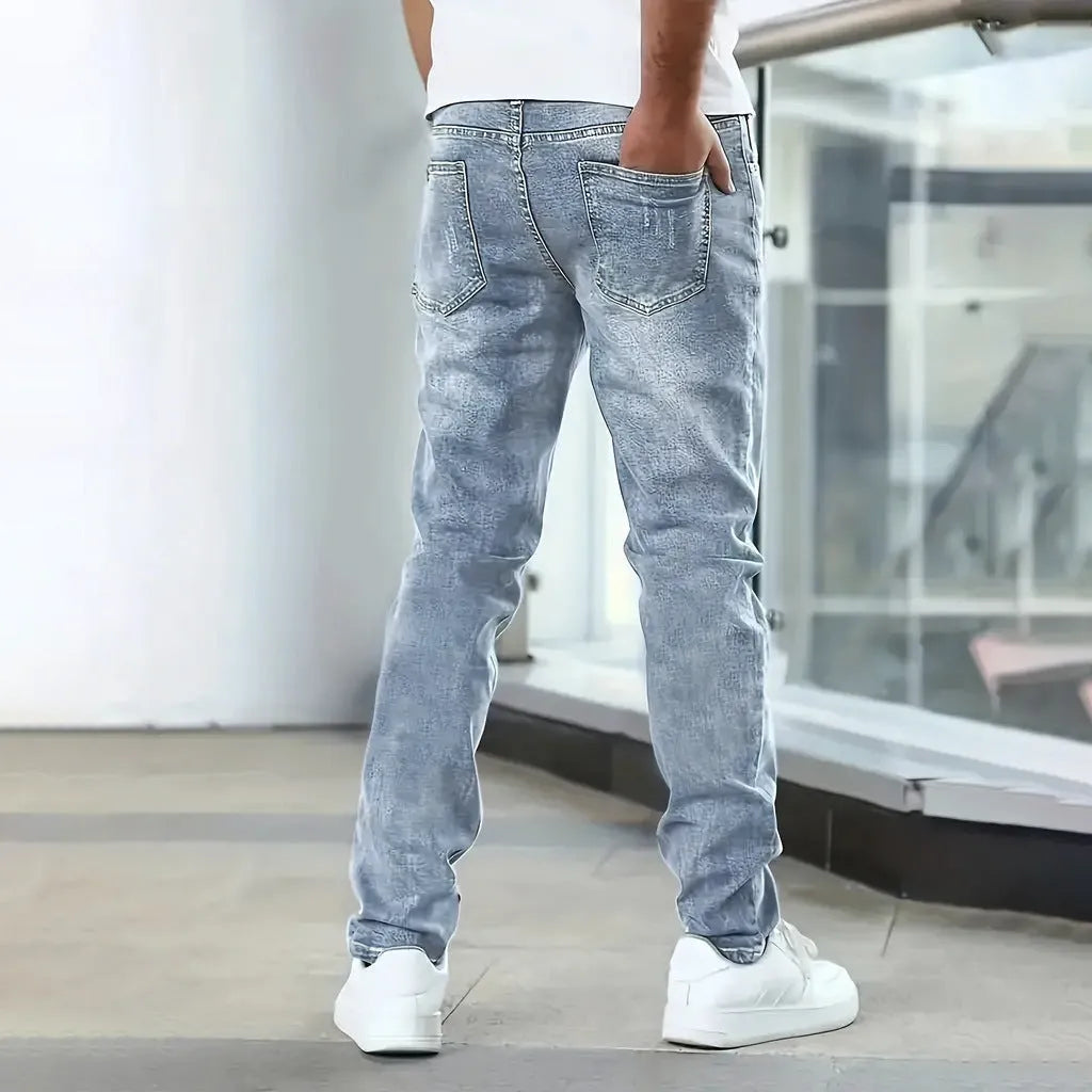 Men's slim-fit stretch jeans in dark blue on a neutral background.