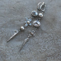 Geometric long XINGX pendant earrings in antique silver with rhinestone details on alloy.