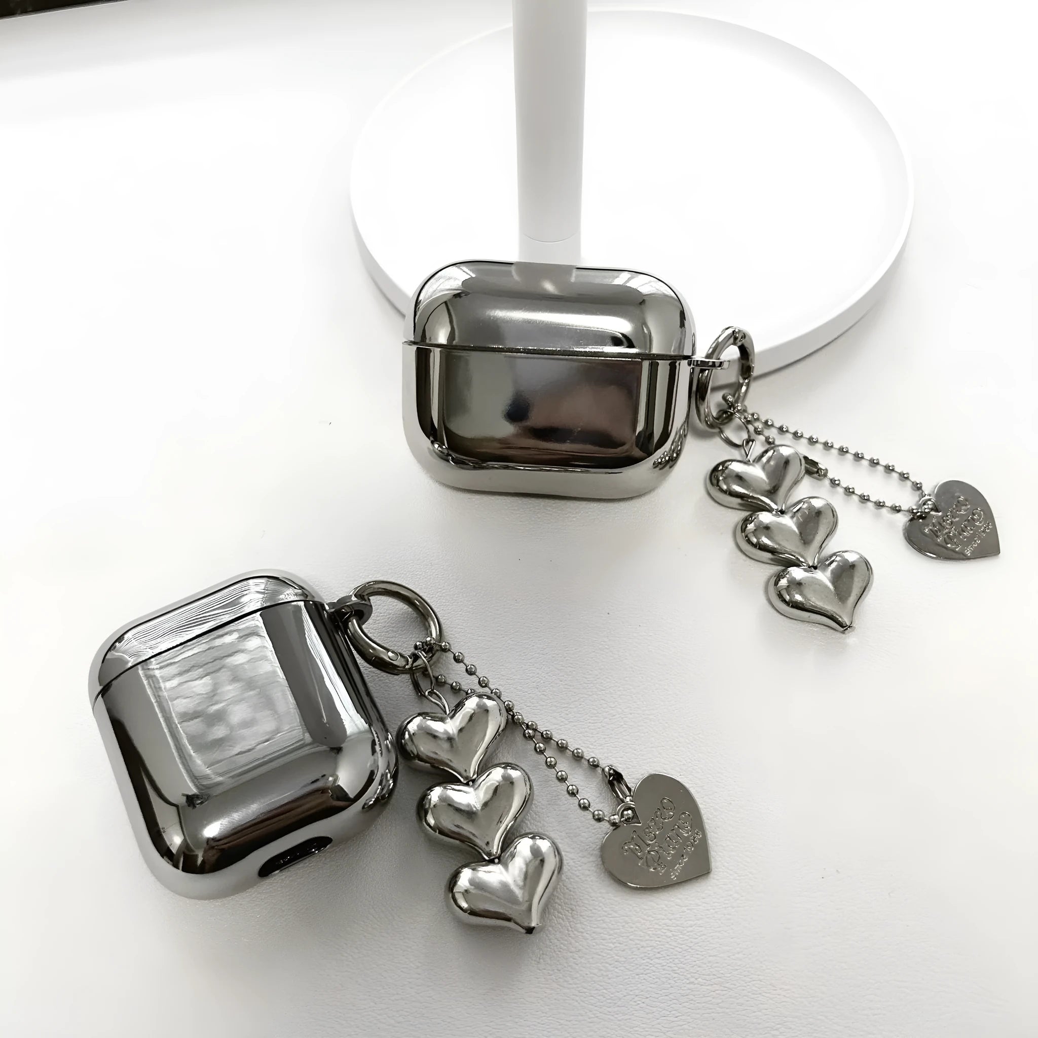 Electroplated solid colour TPU AirPods case with heart pendant charm and chain attachment