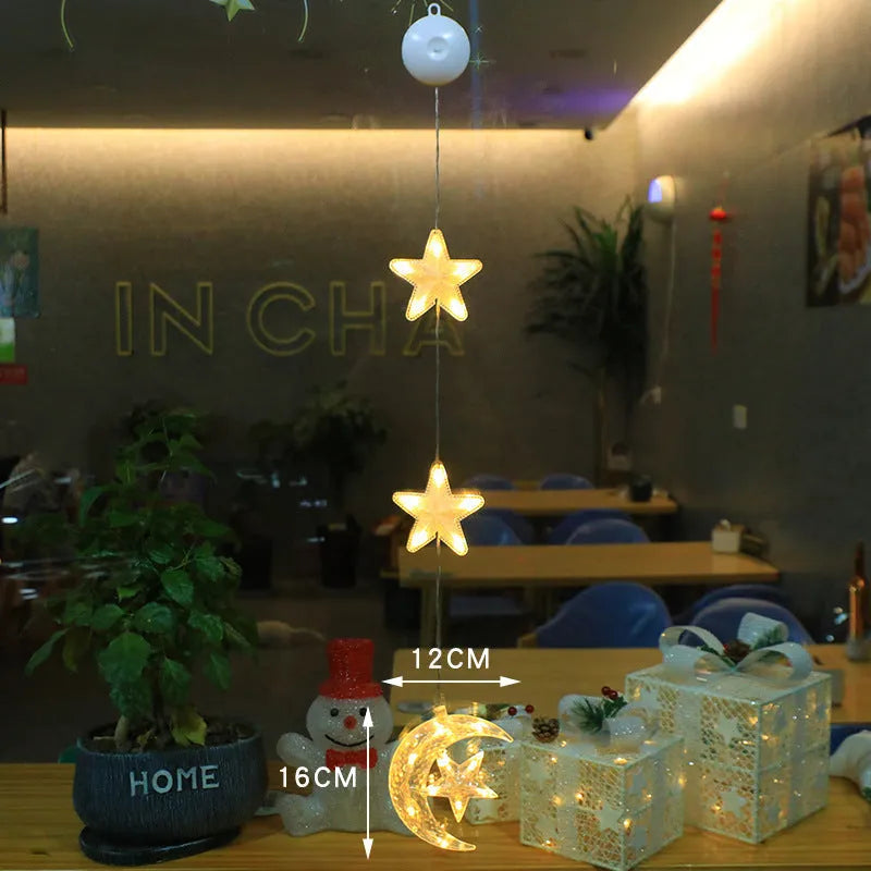 Set of three battery-powered LED Christmas pendant lights with suction cups, showing star, tree, and deer designs.
