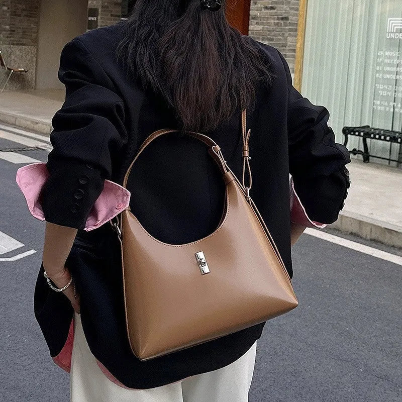 Genuine leather dumpling-shaped crossbody shoulder bag in apricot colour with street-trend details.