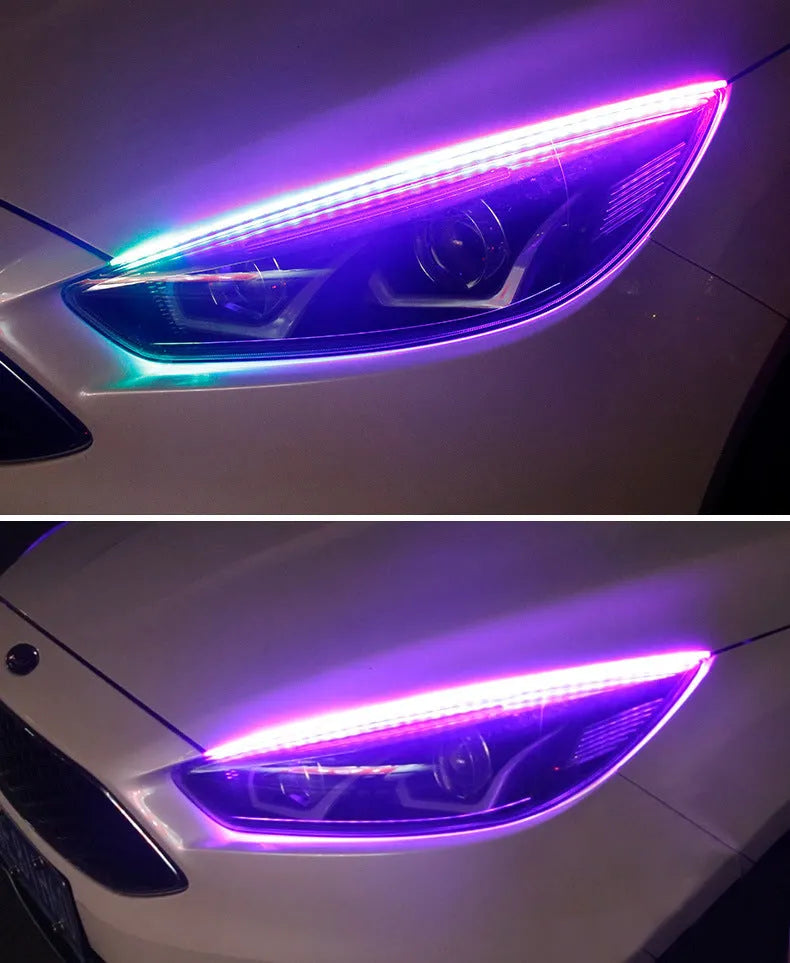 Close-up of a multi-colour RGB LED daytime running light strip with a remote control on a car bumper.