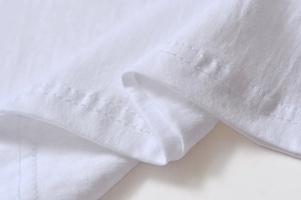 White cotton overalls with round neck and short sleeves in loose pullover style