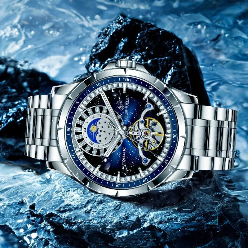 Men's silver alloy automatic watch with blue dial and stainless steel butterfly clasp strap.