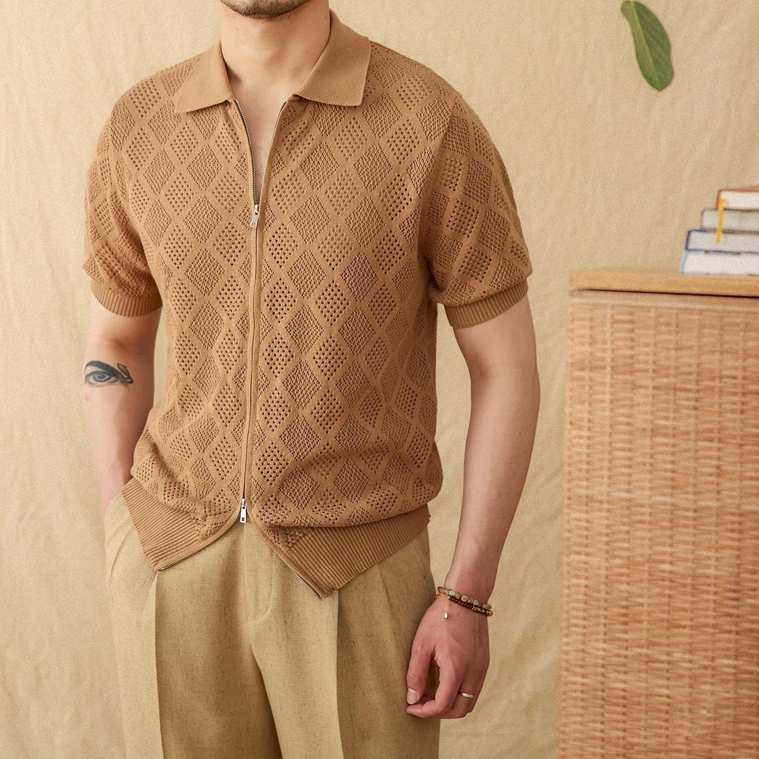 Light brown cotton short sleeve cardigan with front zipper and lapel collar laid flat.