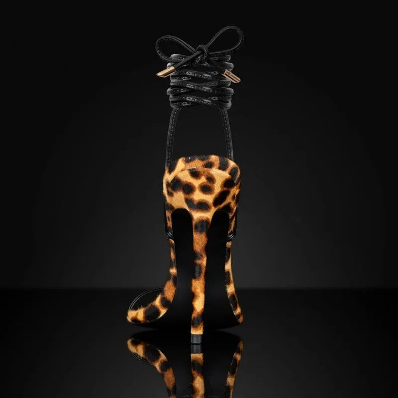 Women's leopard print Roman sandals with a pointed toe and lace-up buckle strap on a rubber sole.
