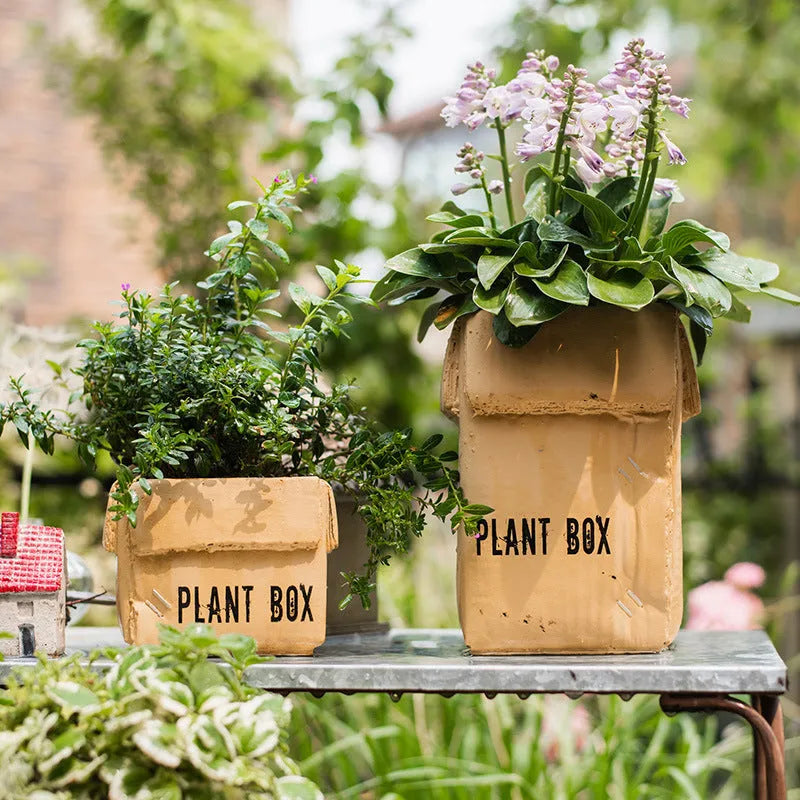 Cement brown paper box style flowerpot with bottom drainage holes for indoor plants