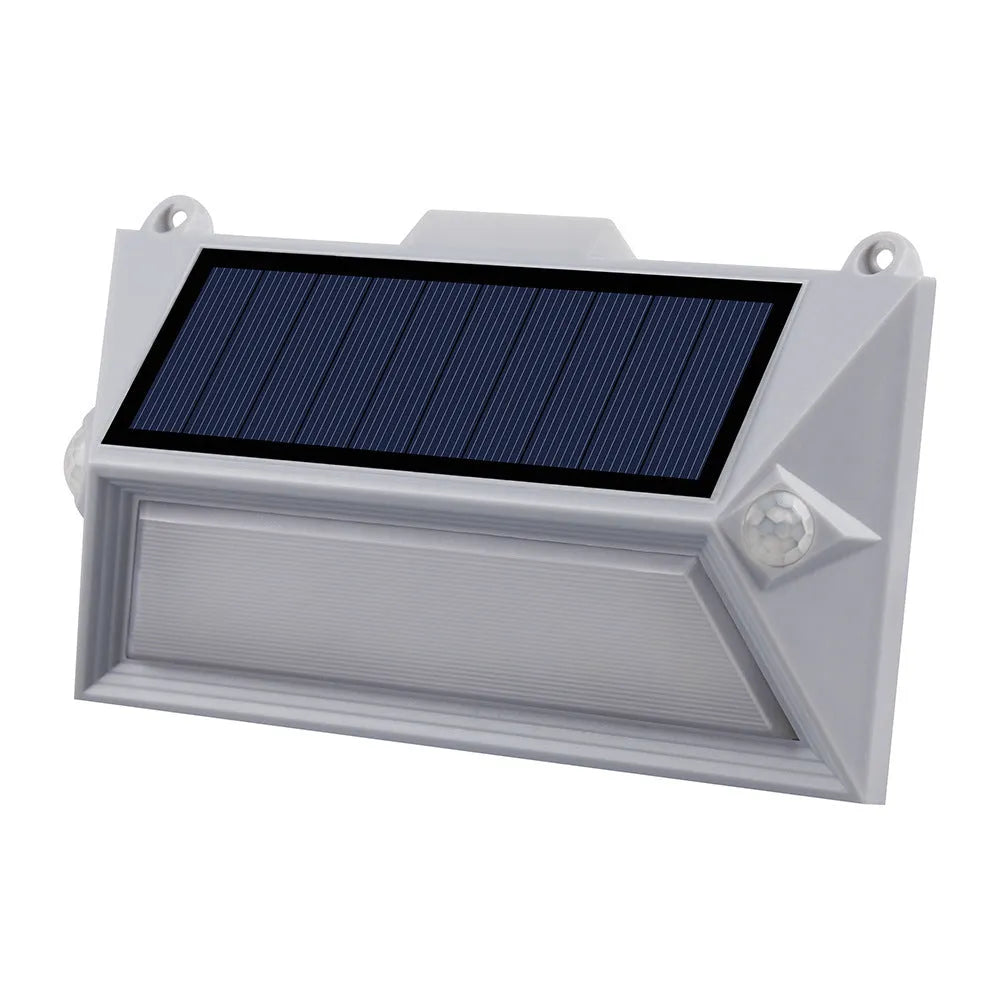 Solar-powered outdoor step light with motion sensor in abstract design on a brick step.