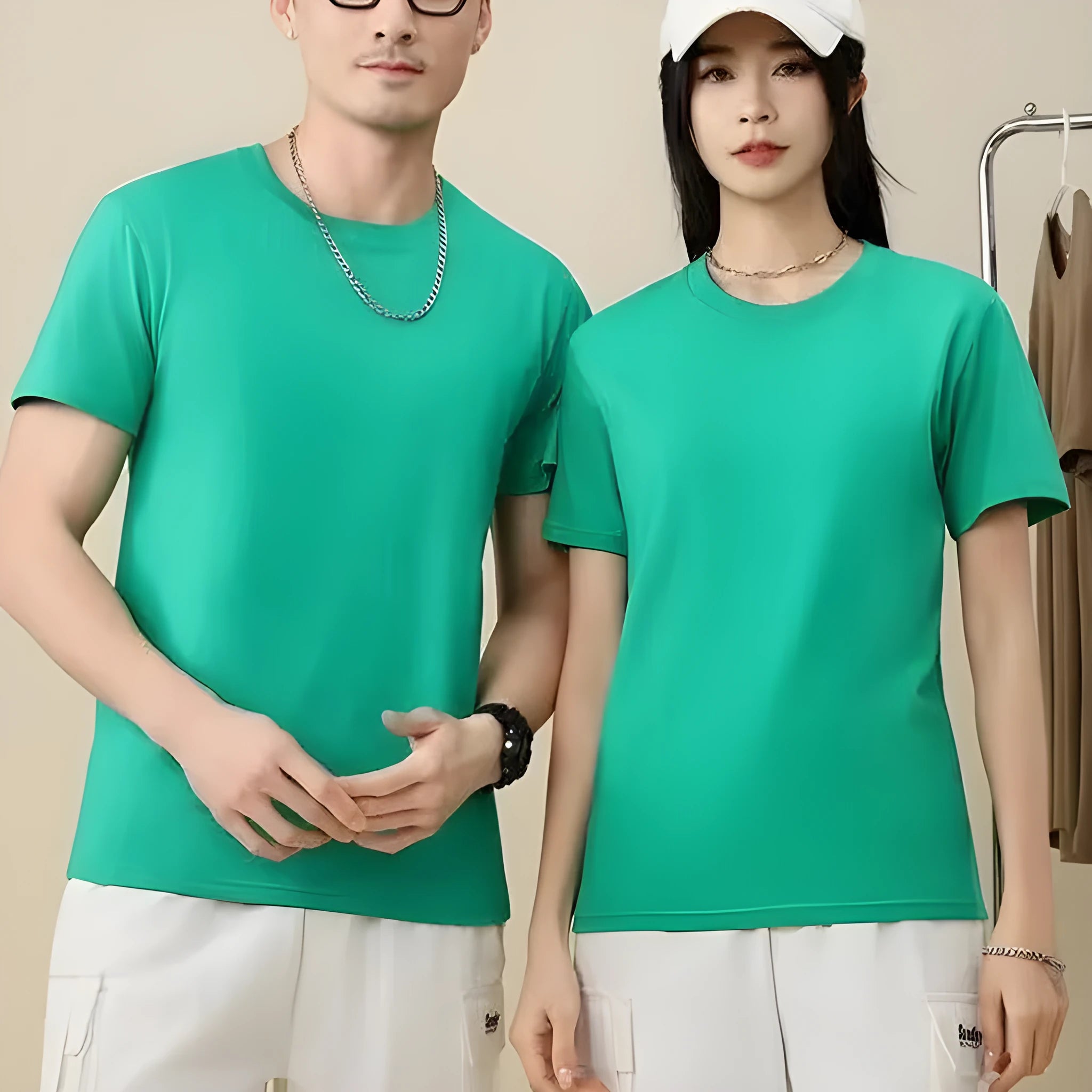 Men's and women's loose-fit cotton T-shirt in solid colours like navy blue, red, and white, shown as a short-sleeve pullover top.