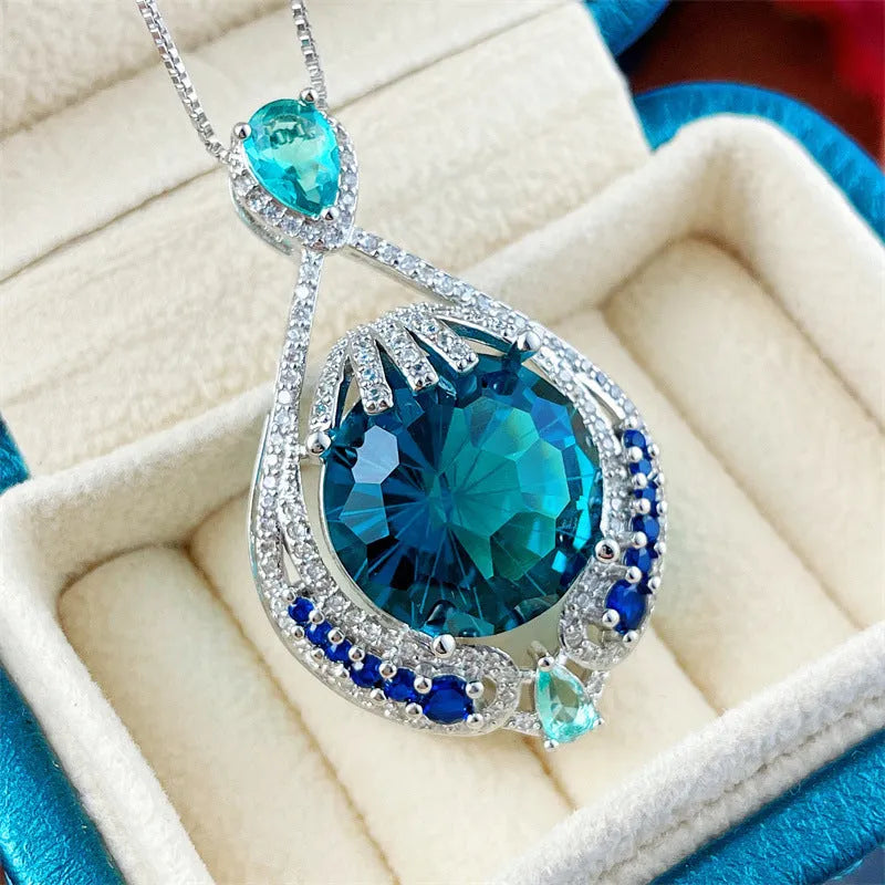 Geometric women's necklace with blue fireworks-cut crystal gems on a water wave chain.