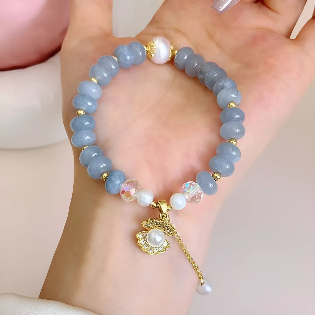 Natural aquamarine pearl shell bracelet on wrist showing adjustable design and handcrafted bead details