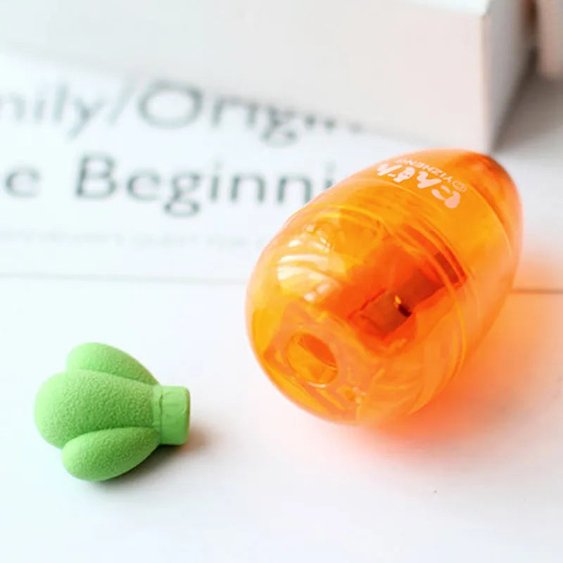 Orange carrot-shaped plastic pencil sharpener with cartoon design showing 7cm handle length