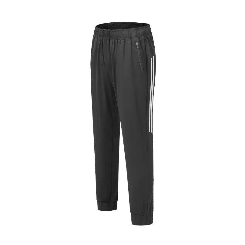 Men's black polyester running trousers with a mid waist fit on a size chart.