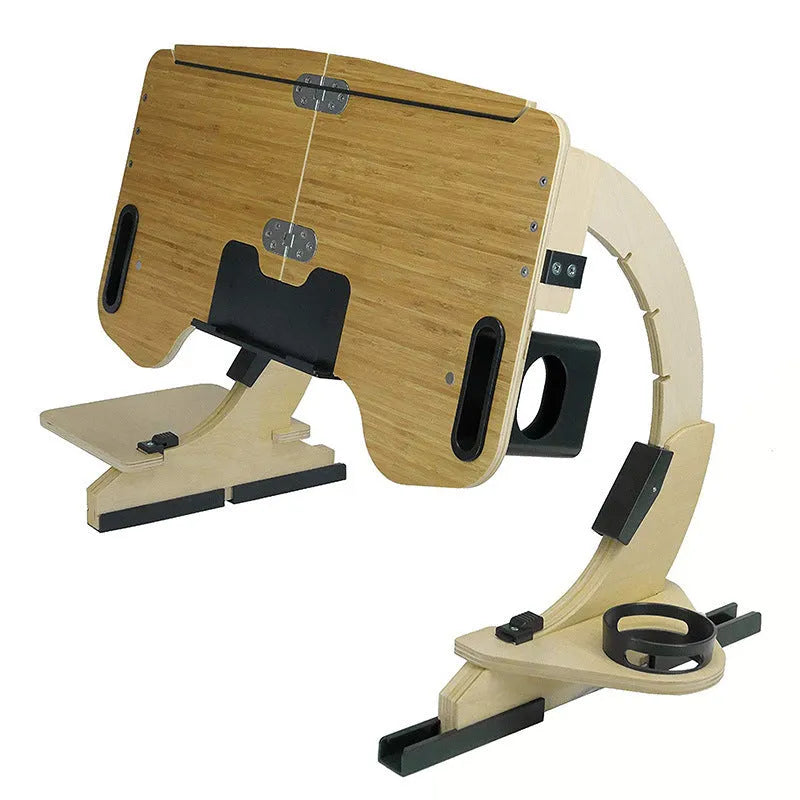 White wooden folding laptop table on a bed at an adjustable angle.