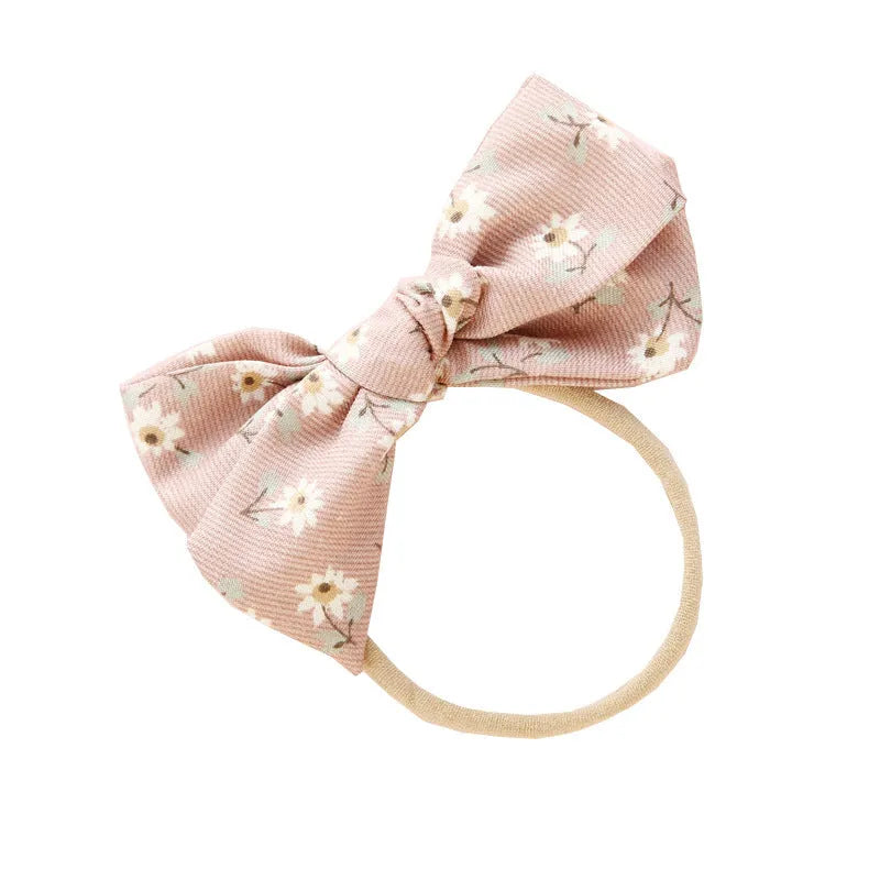 Children's cloth hair band with knotted bow design showing Snow White princess pattern