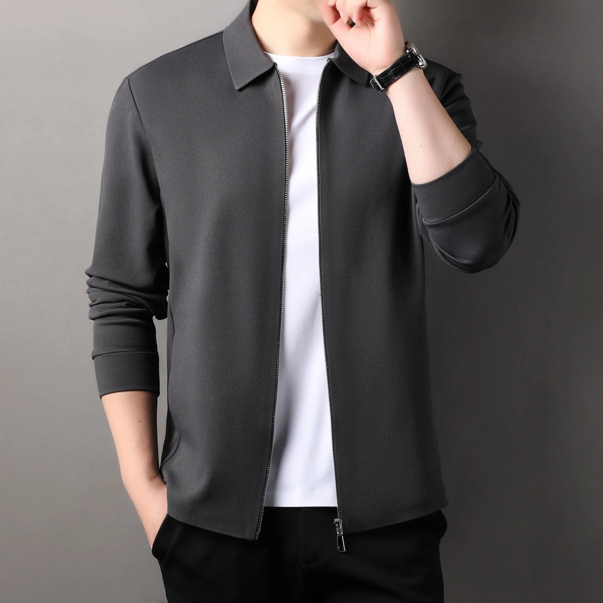 Men's black polyester jacket with long sleeves and a straight hem on a hanger.