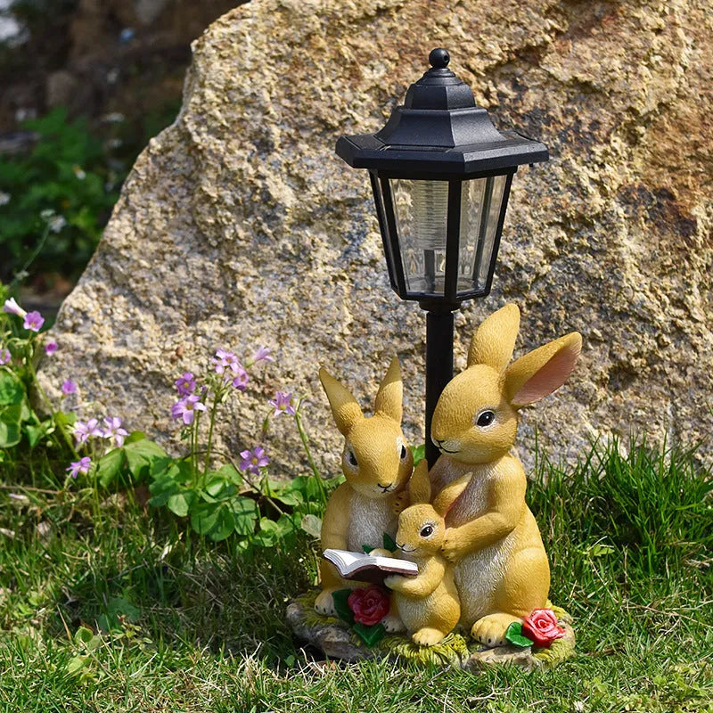 Hexagonal solar garden lamp with animal sculpture decoration in outdoor setting