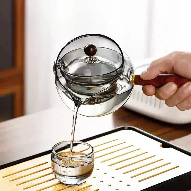 Rotating glass teapot with wooden handle and stainless steel infuser basket