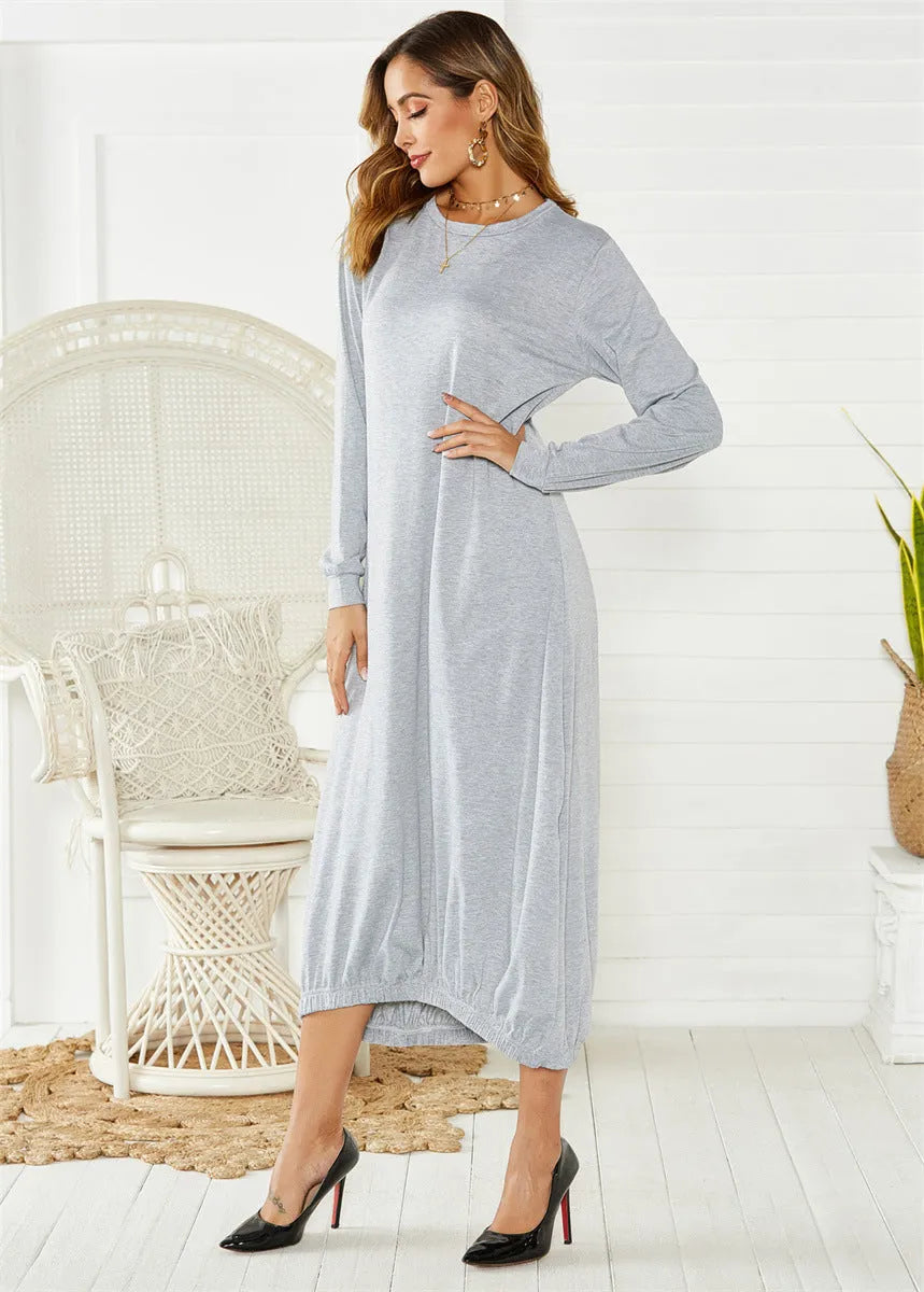 A loose, long black lantern dress with a lace-up crew neck on a mannequin.