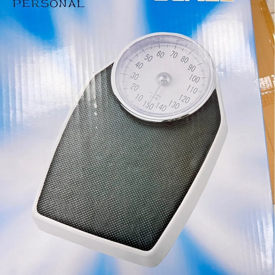 Black mechanical body weight scale with large analogue dial on a simple platform.