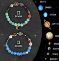 Set of two natural stone beaded zodiac bracelets with adjustable cords on a flat surface.