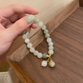 White multi-layer beaded bracelet with small rice-shaped beads in geometric ethnic design