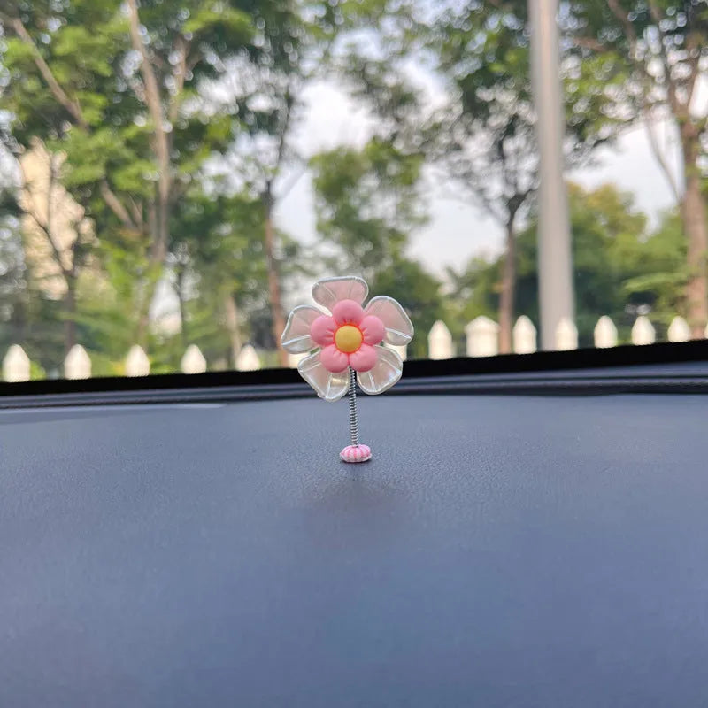 Small plastic colourful swing car decoration shown in multiple colour options.