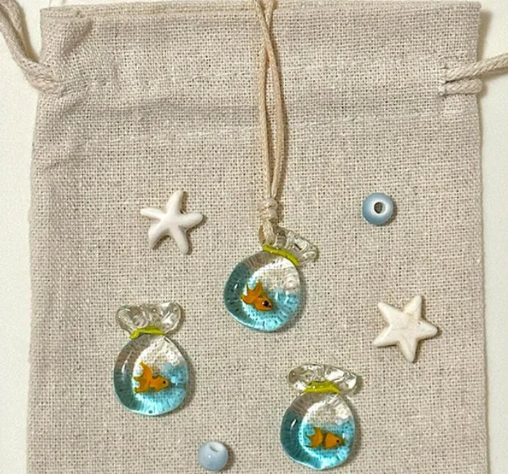 Women's world style necklace with coloured glaze joker pendant on a cotton linen clavicle chain.