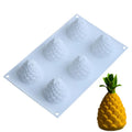 A green silicone baking mould with six cavities shaped like pineapples and pine cones.