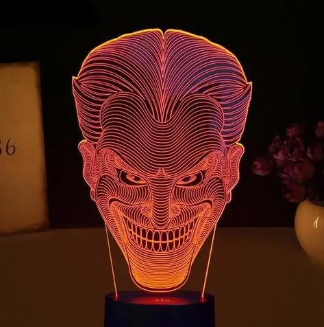USB-powered 3D acrylic LED table lamp with remote control on a desk, displaying colourful gradient lighting.