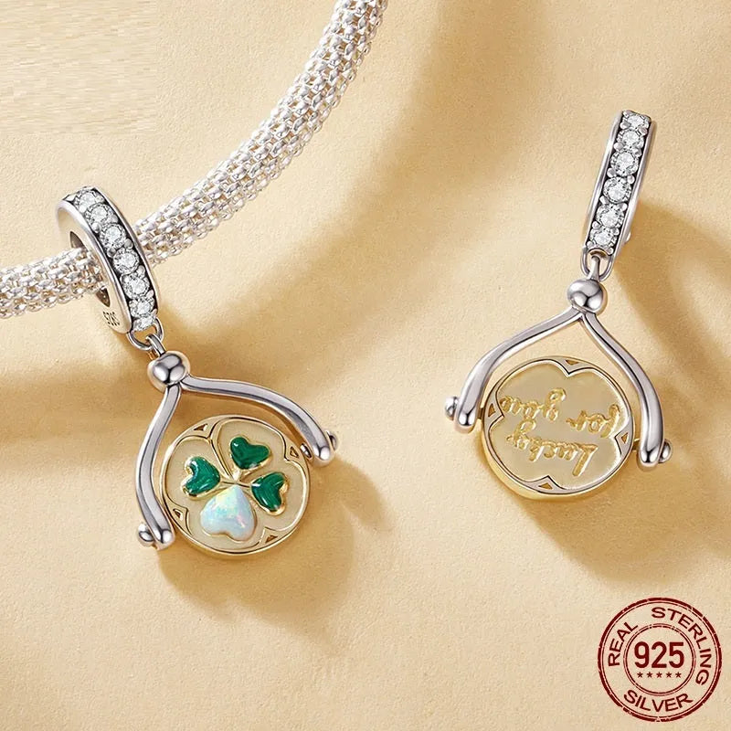 925 silver rotating card pendant with four-leaf clover pattern and wing element on white background